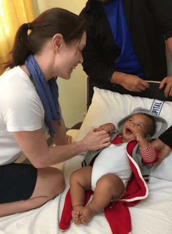 A young patient in Tonga engages with Rebecca during her volunteer work in the Pacific nation.